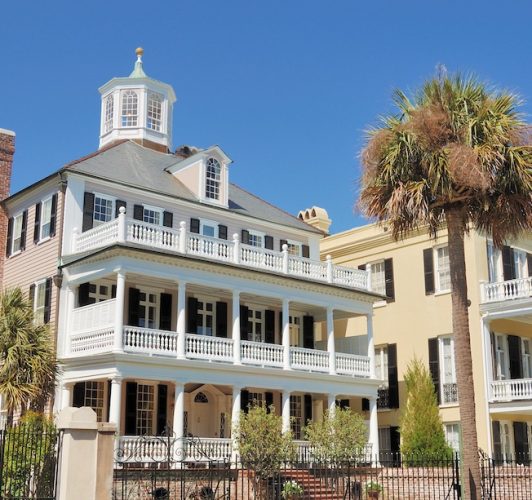 three-story home with white railings