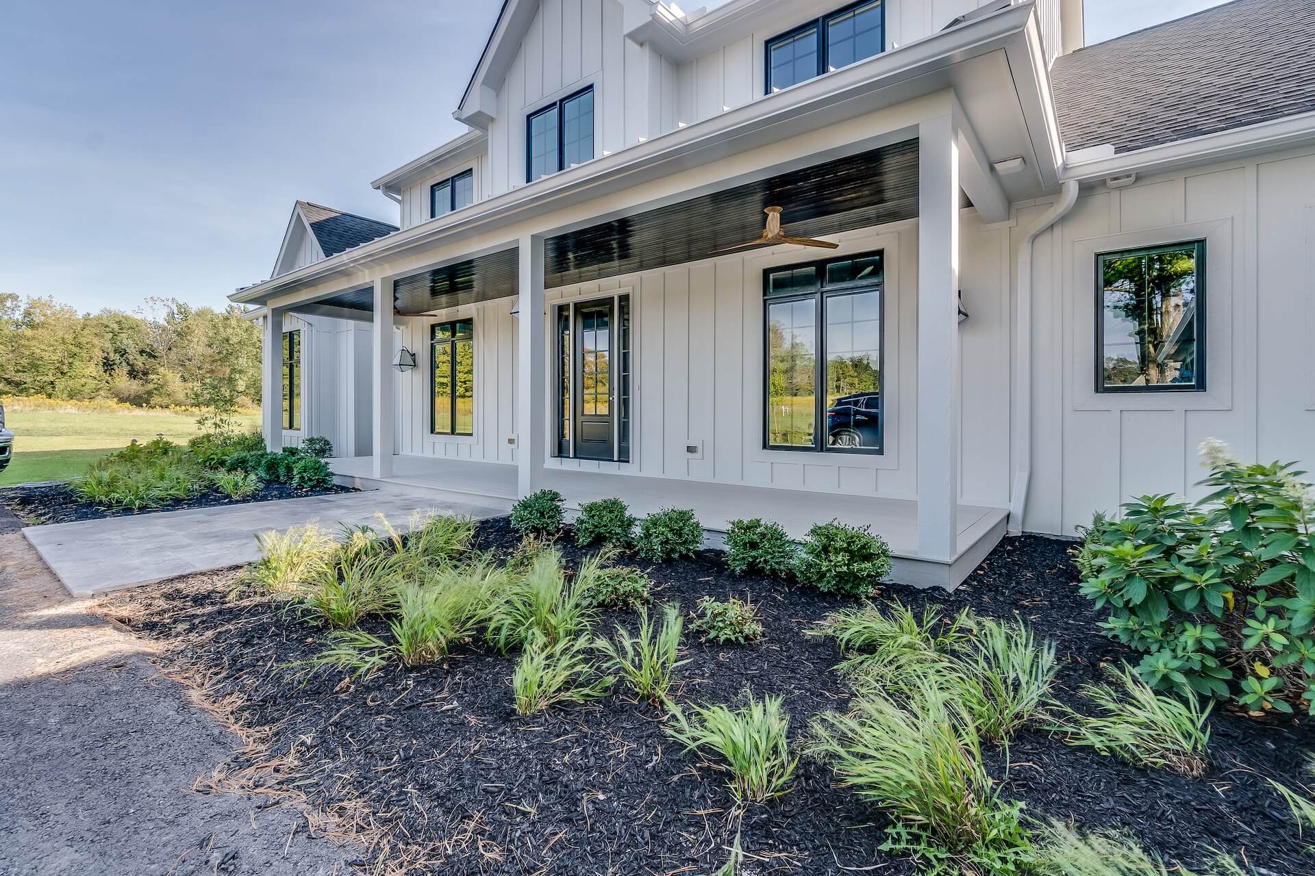 facade of white two-story home with black window frames