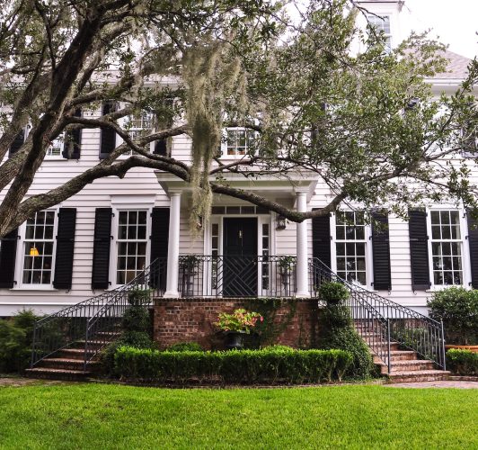 facade of white home with balck front door