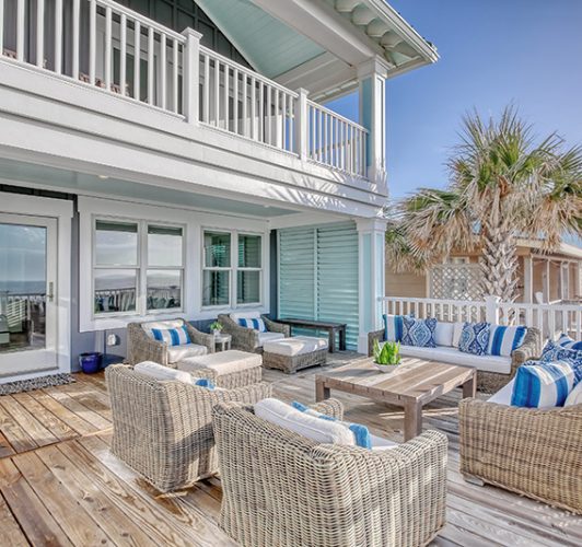 coastal home deck with patio furniture