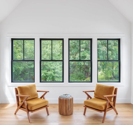 Sunroom with while walls and black window frames