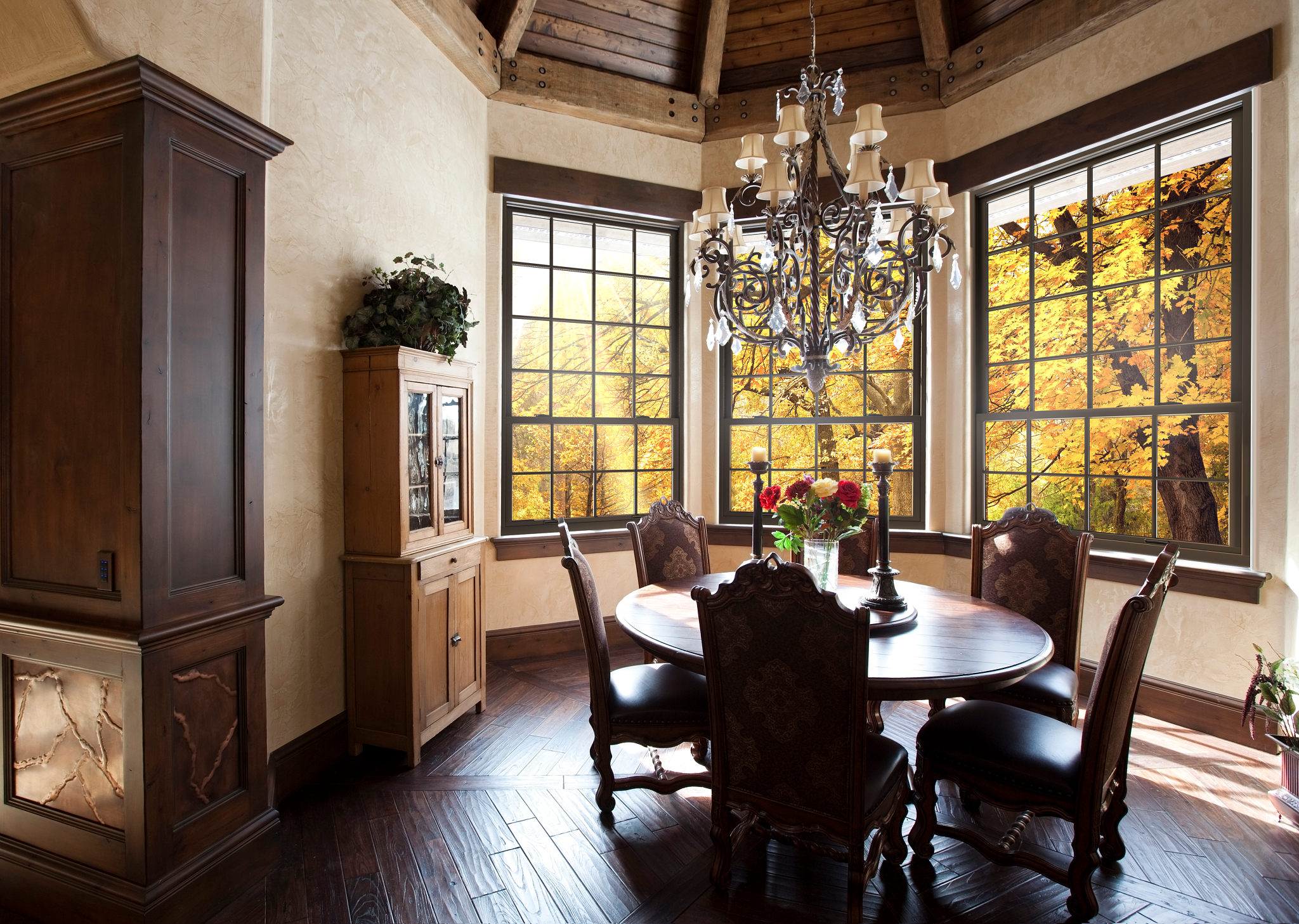 dining room with chandelier and tall wooden windows