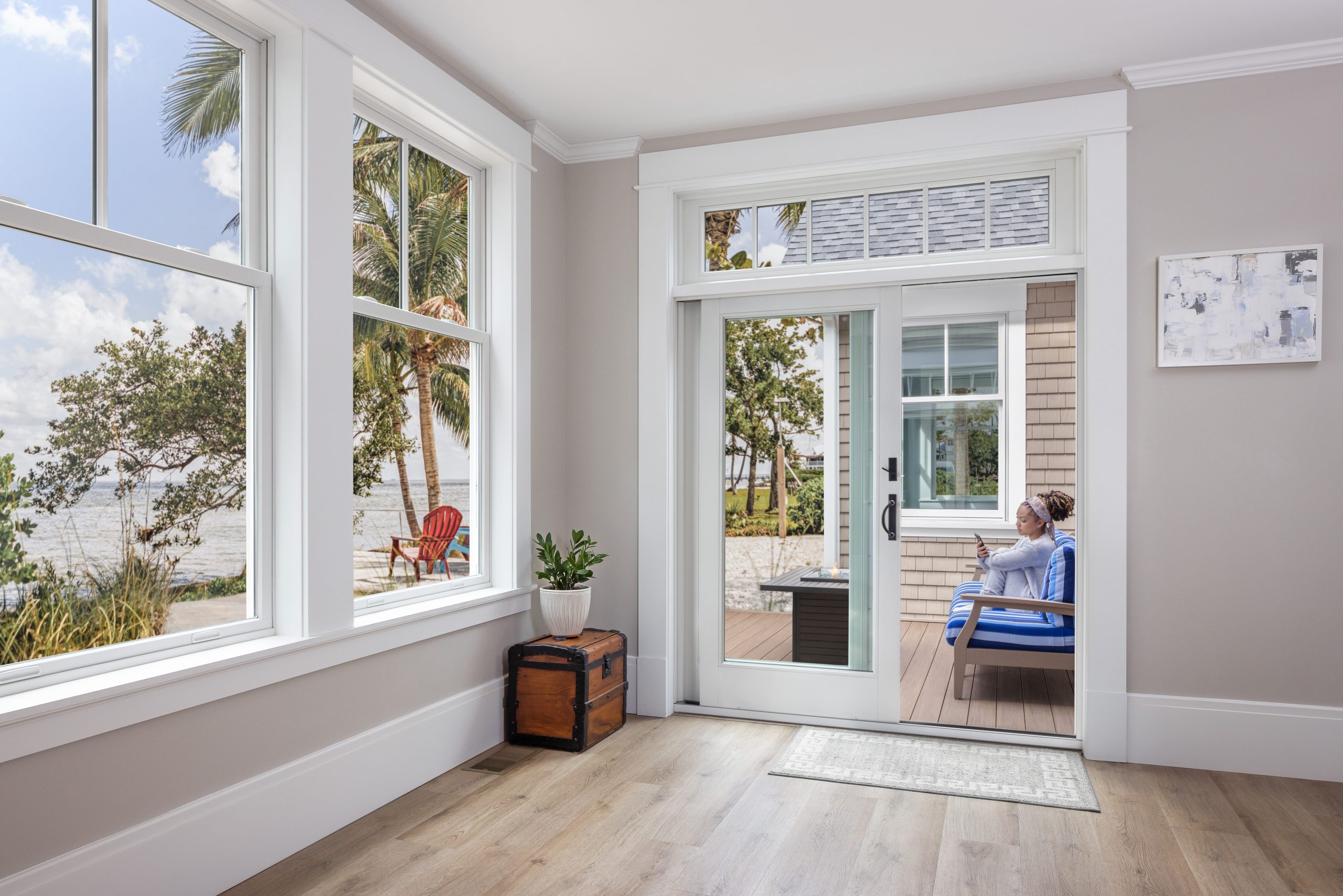 woman sitting on couch by sliding patio door